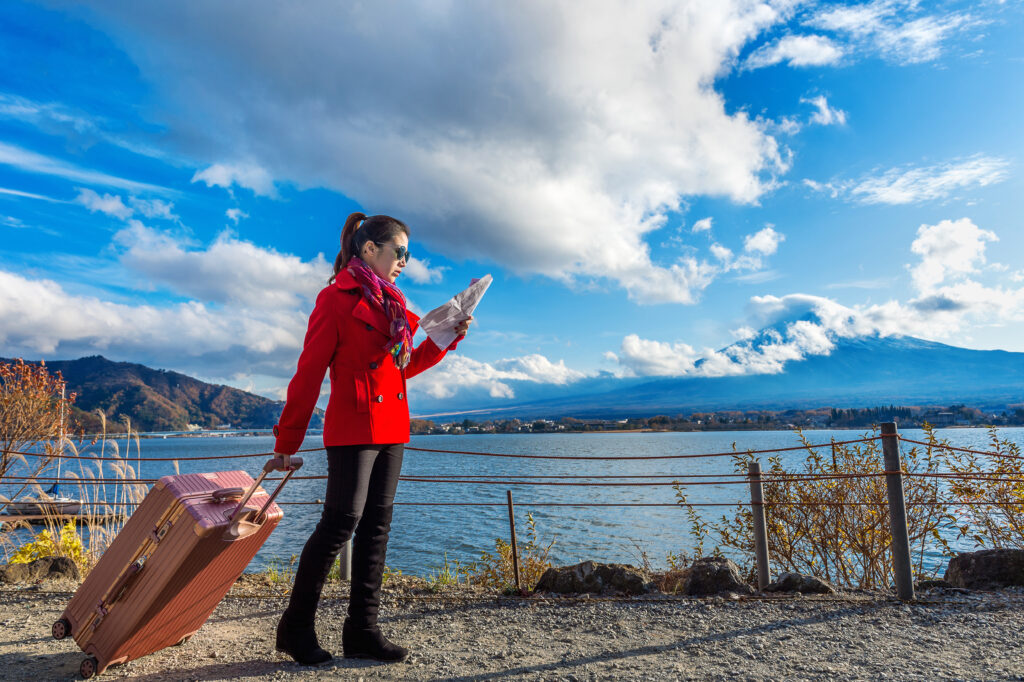 tourist with baggage map fuji mountain kawaguchiko japan
